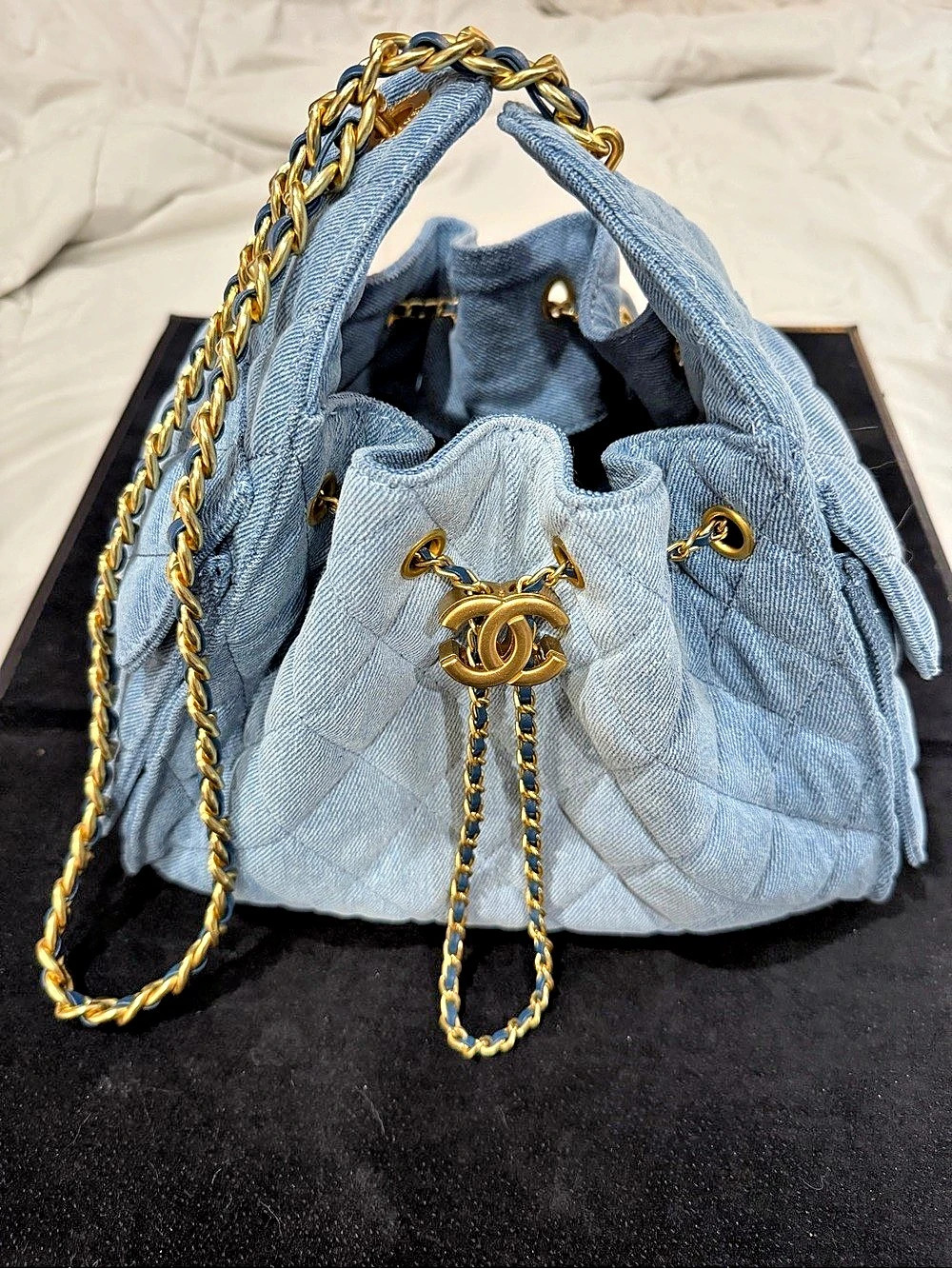 Chanel 25 handbag in washed denim and gold-tone metal